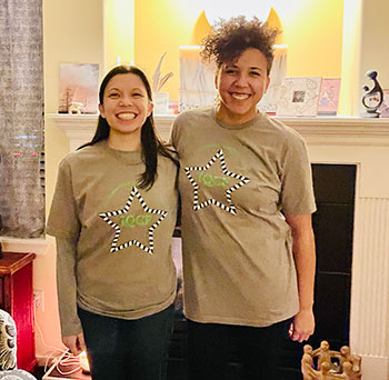 Two young women wearing festival shirts